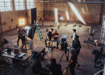 Film crew setting up lights and cameras on set