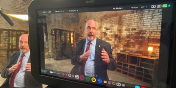 Crew reviewing video footage on monitor during a commercial shoot.